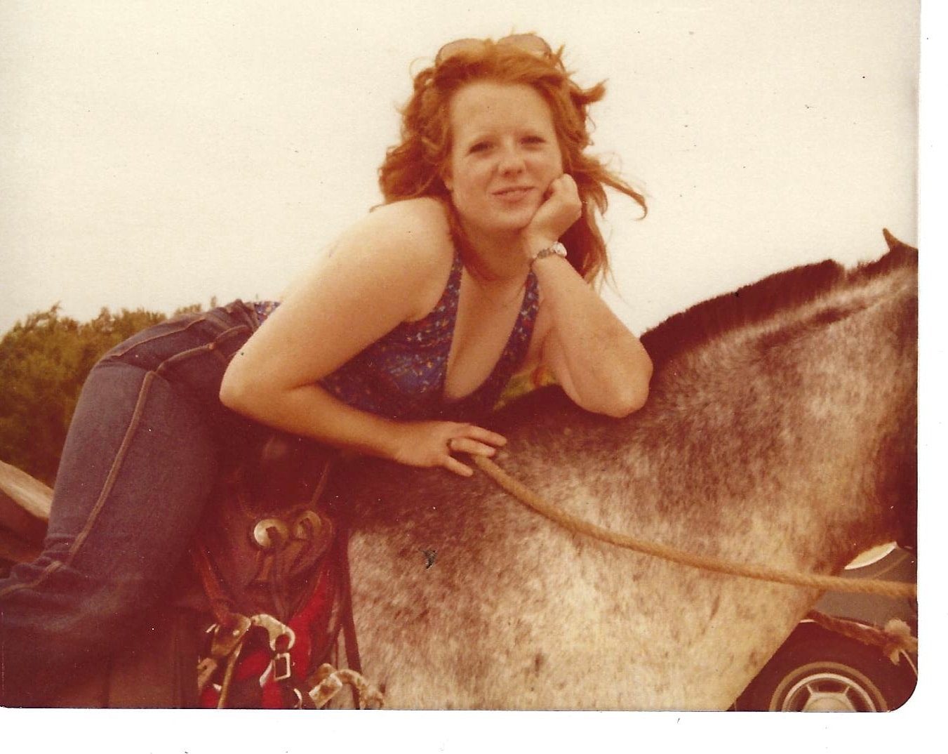 Guinndolyn Sharpe on horseback at night in an arena